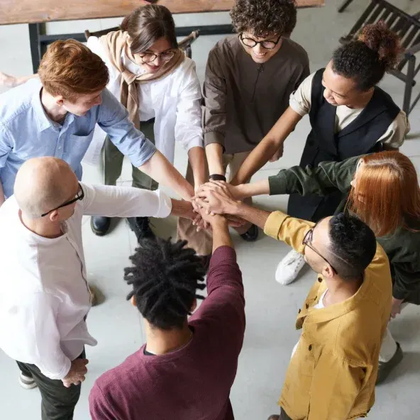 A group of professionals joining hands as a sign of teamwork